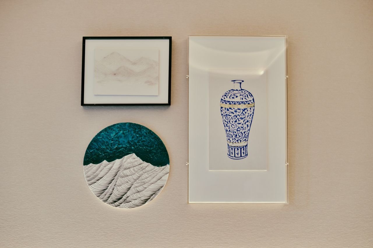 A collection of framed minimalist art on a textured wall, perfect for home decor.